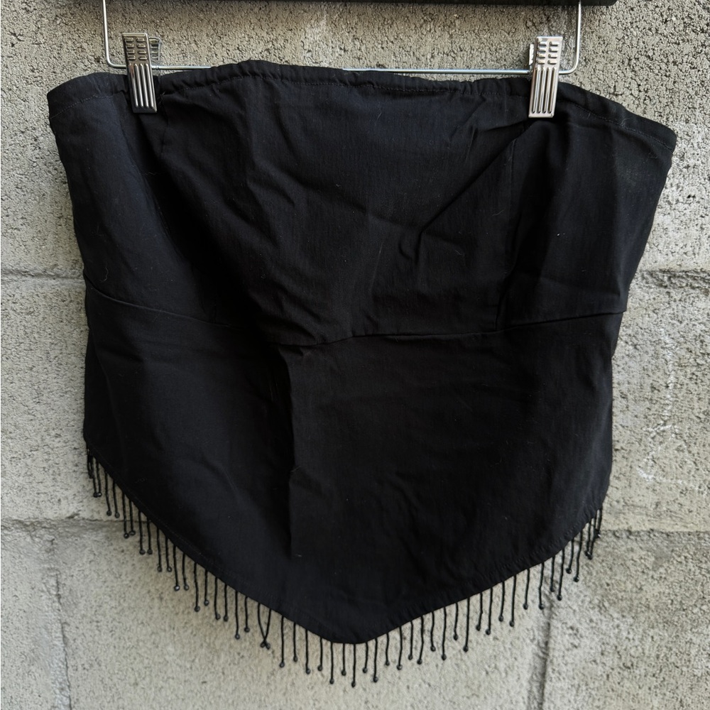 Strapless top with beaded fringe.